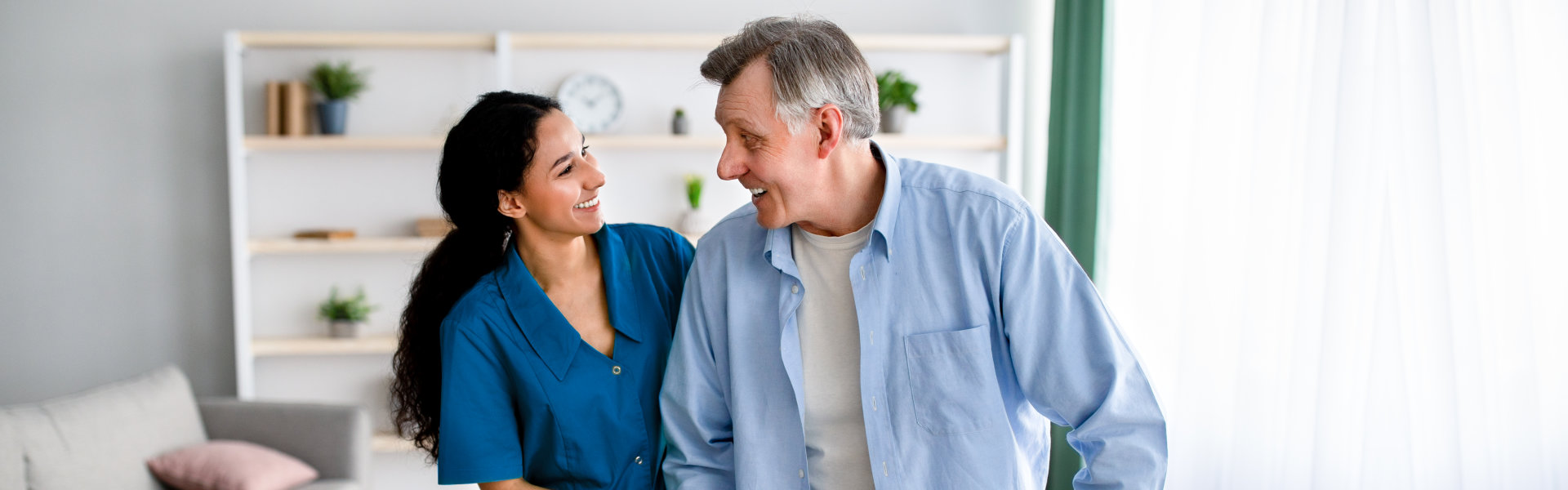 elderly man and nurse smiling to each other